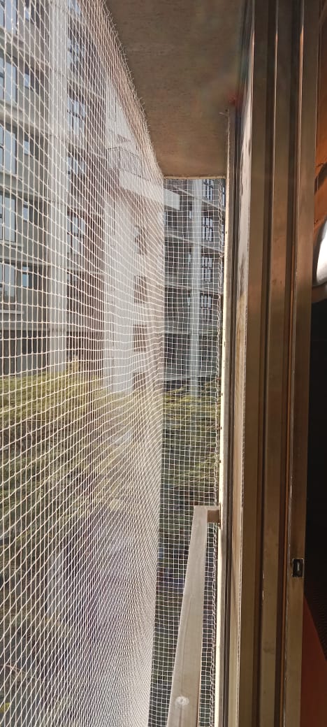 White Garware bird netting on a high-rise balcony
